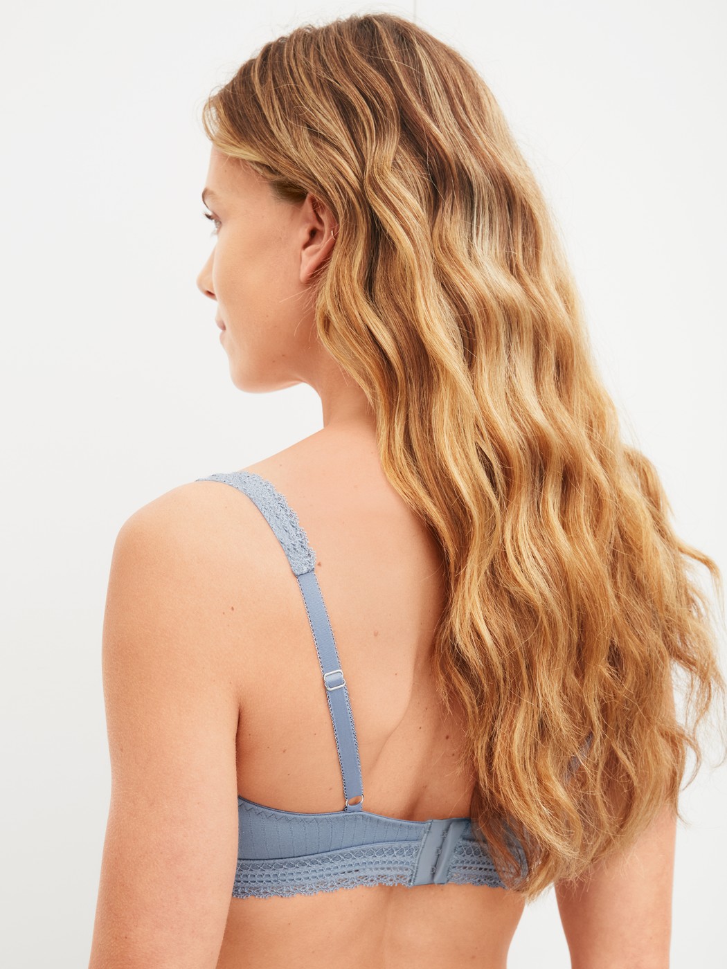 Women model is wearing Soft bra made of Modal in Blue, Lace from the Etude Ajours series by CALIDA, Back view
