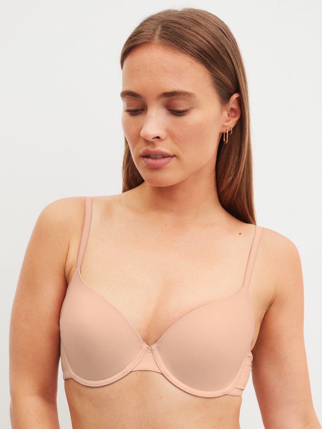 Women model is wearing Moulded Bra with Multiway Straps made of Polyamide in Beige, Unicoloured from the Sleek Skin series by CALIDA, Front view