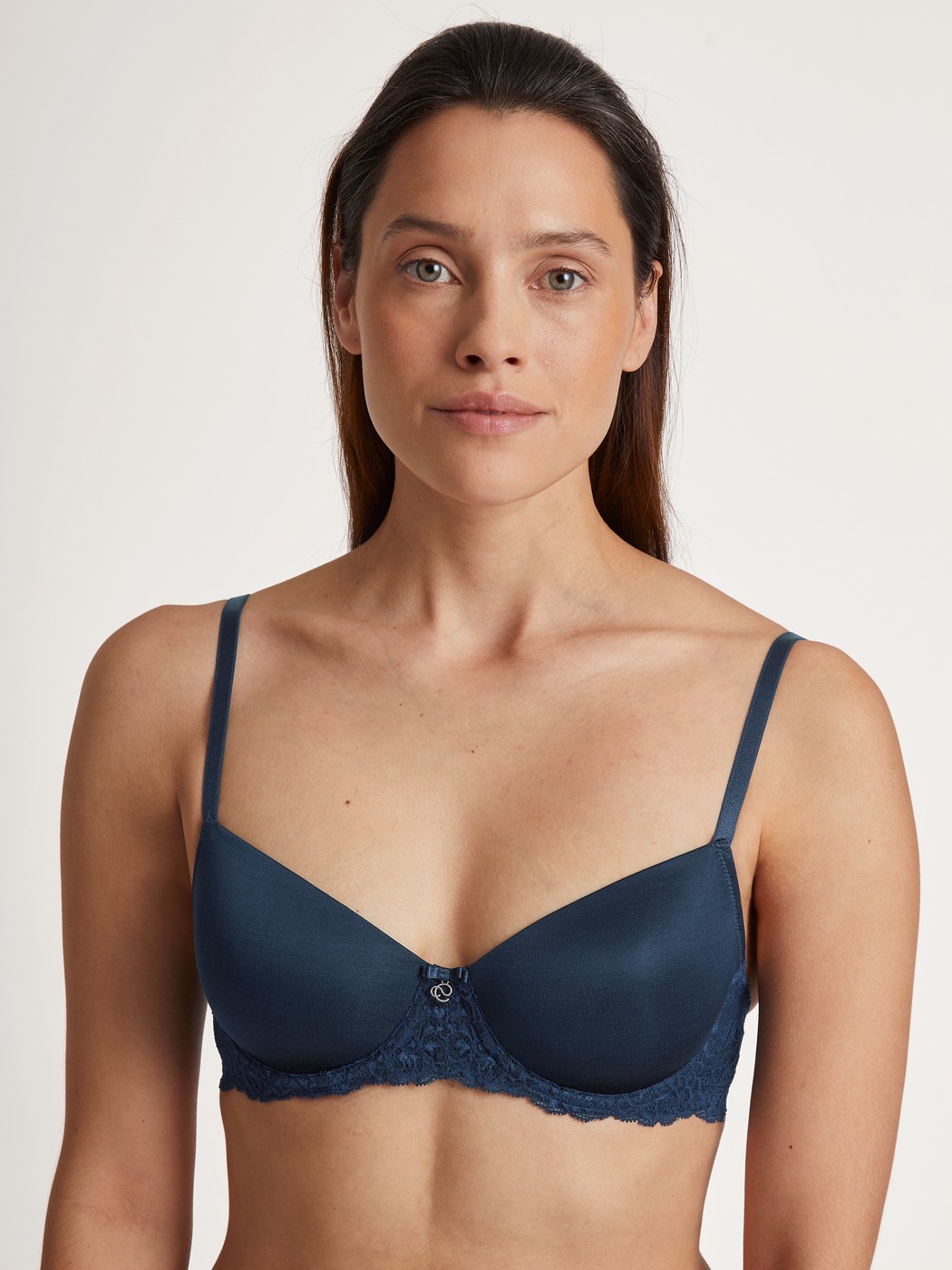 Women model is wearing Underwired T-shirt bra with padding made of Viscose in Blue, Lace from the Sensual Secrets series by CALIDA, Front view
