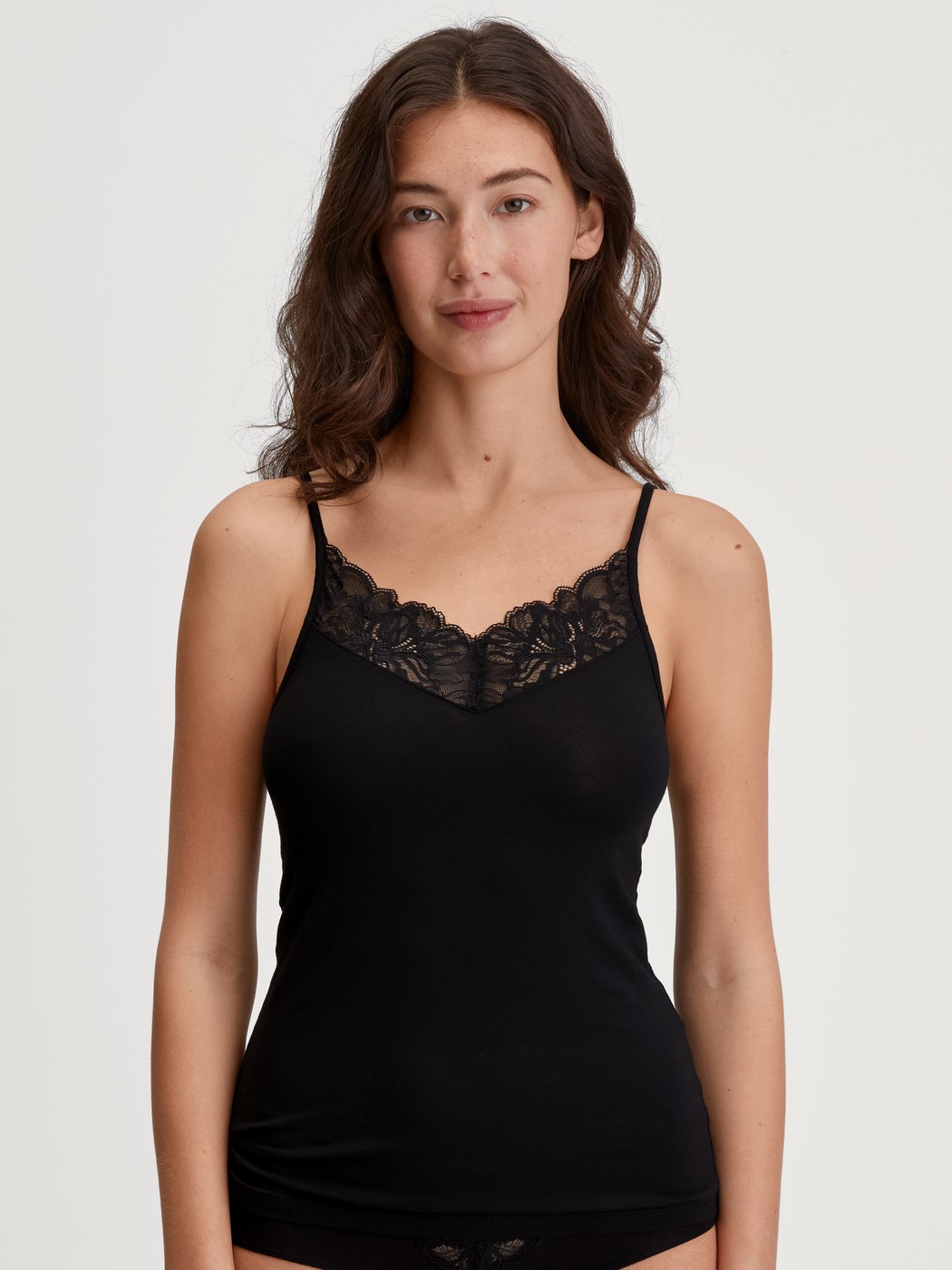 Women model is wearing Spaghetti top made of Modal in Black, Lace from the Seduction Lace series by CALIDA, Front view
