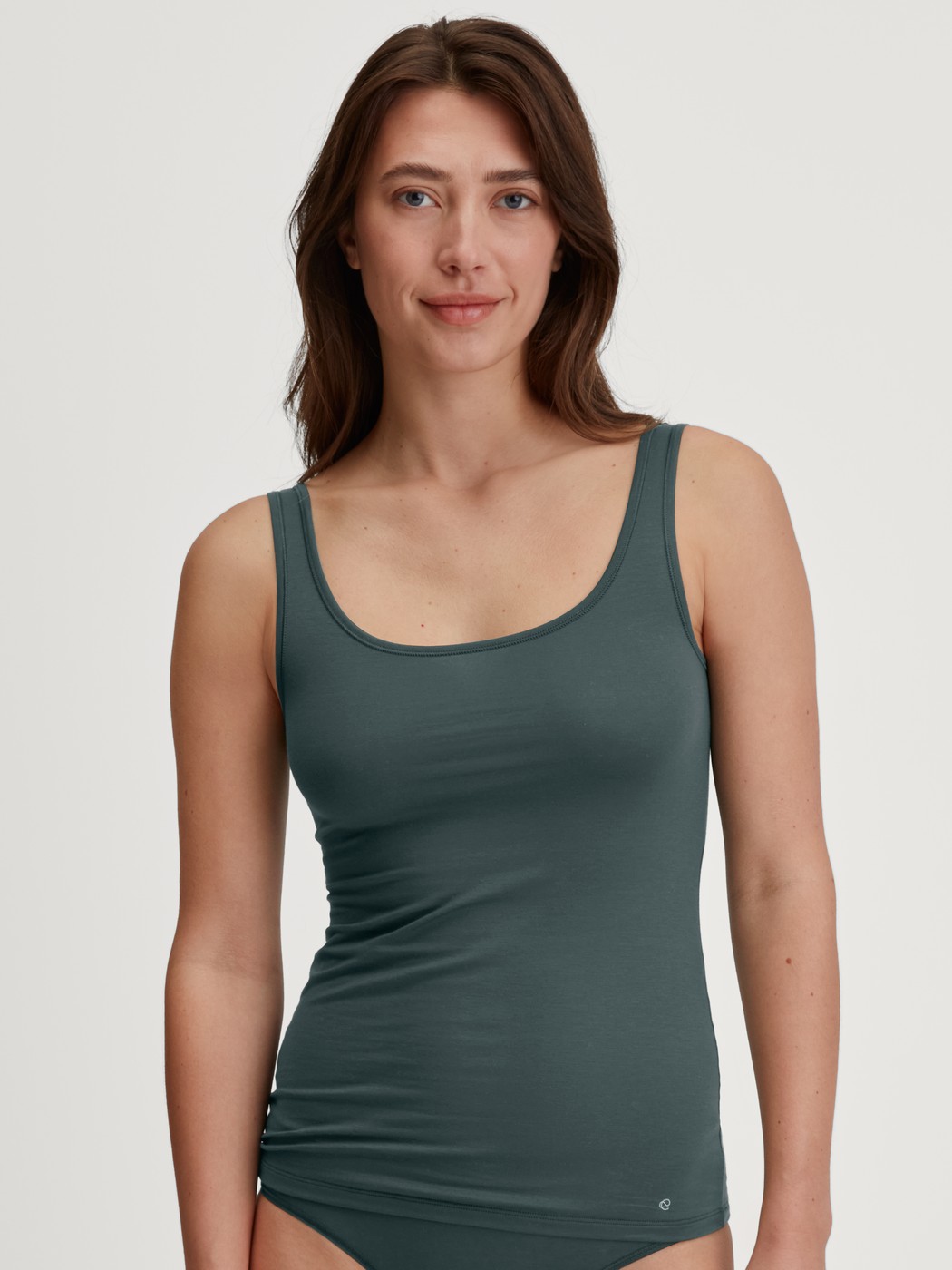 Women model is wearing Tank top made of Cotton in Green, Unicoloured from the Natural Comfort series by CALIDA, Front view