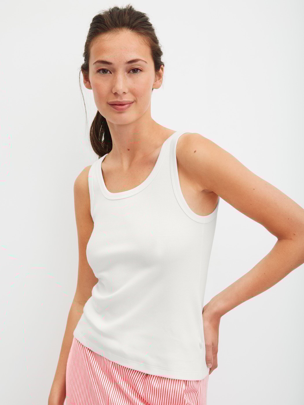 Women model is wearing Tank top made of Cotton in White, Unicoloured from the Favourites Beach series by CALIDA, Front view