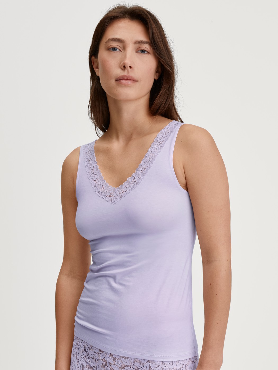 Women model is wearing Tank top made of Cotton in Purple, Lace from the Natural Comfort Lace series by CALIDA, Front view