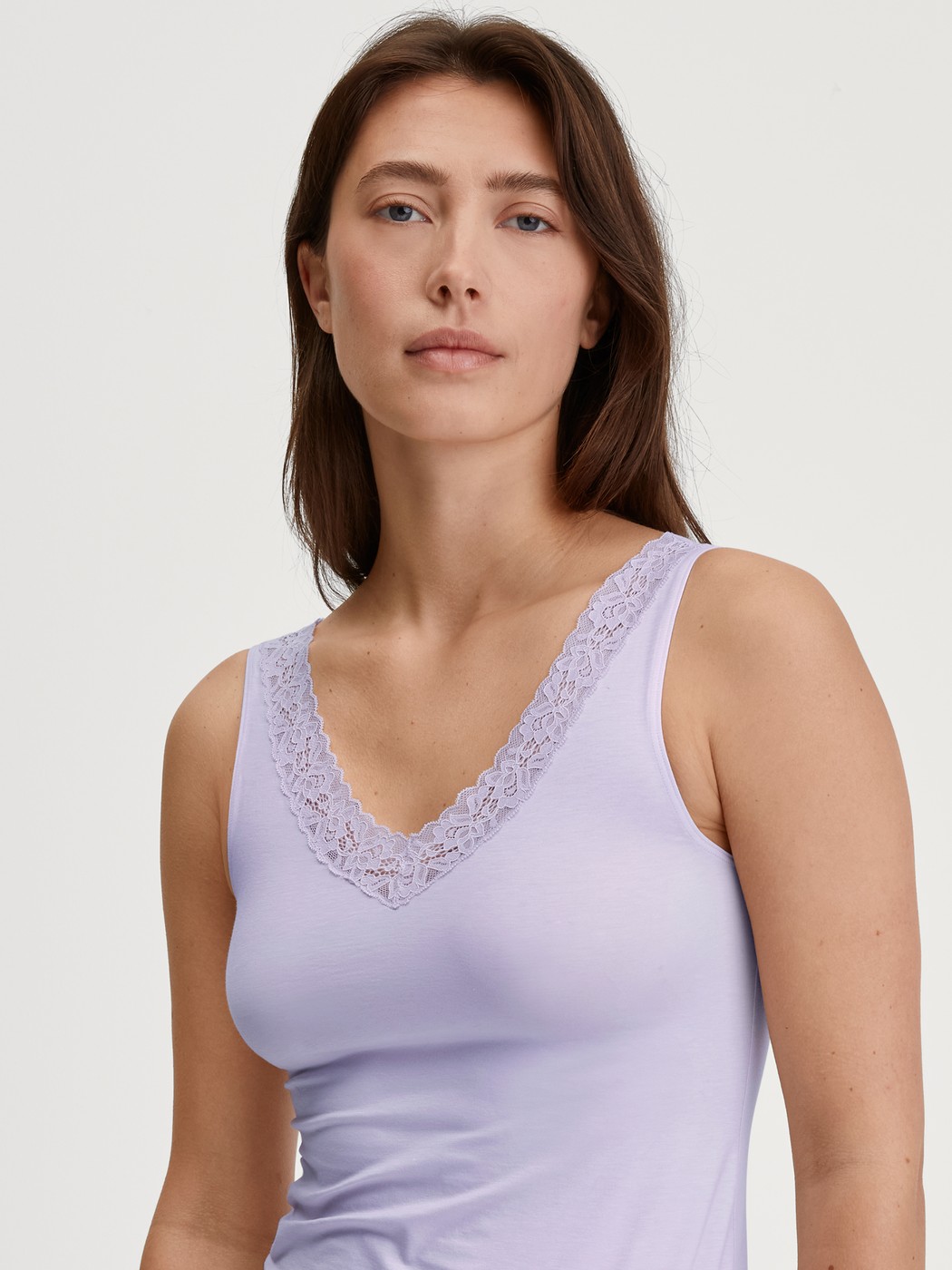 Women model is wearing Tank top made of Cotton in Purple, Lace from the Natural Comfort Lace series by CALIDA, Front view