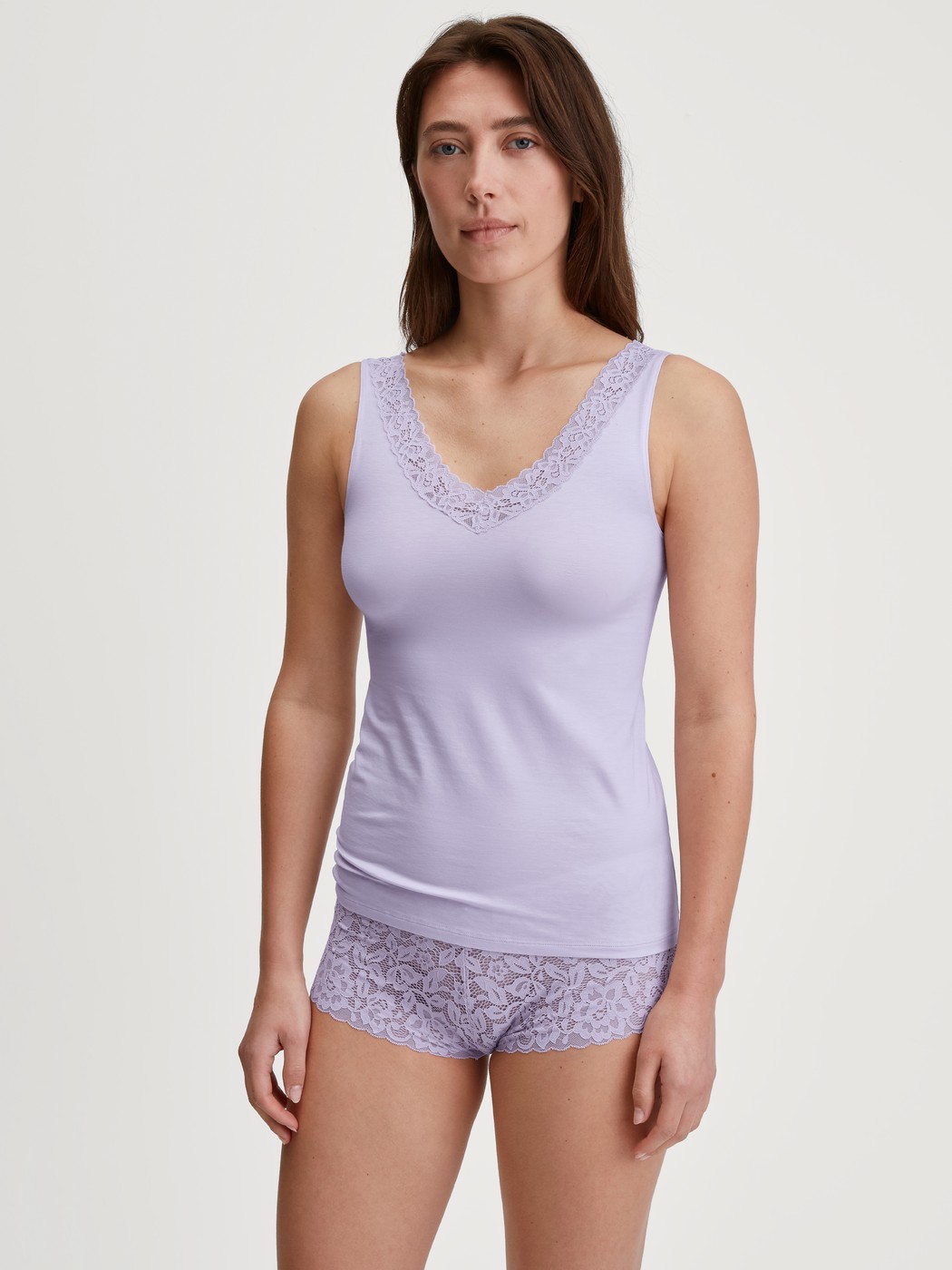 Women model is wearing Tank top made of Cotton in Purple, Lace from the Natural Comfort Lace series by CALIDA, Outfit