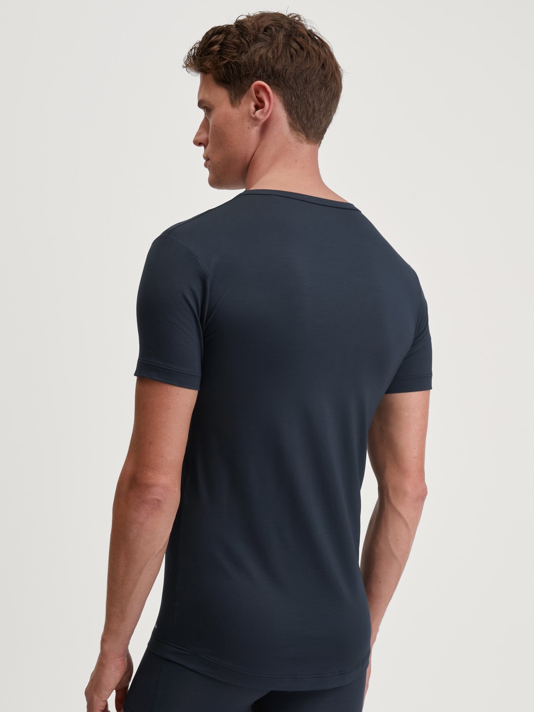 Herren-Model trägt Kurzarm-Shirt, Rundhals aus Modal in Blau, Einfarbig aus Serie Balanced Day von CALIDA, Rückansicht