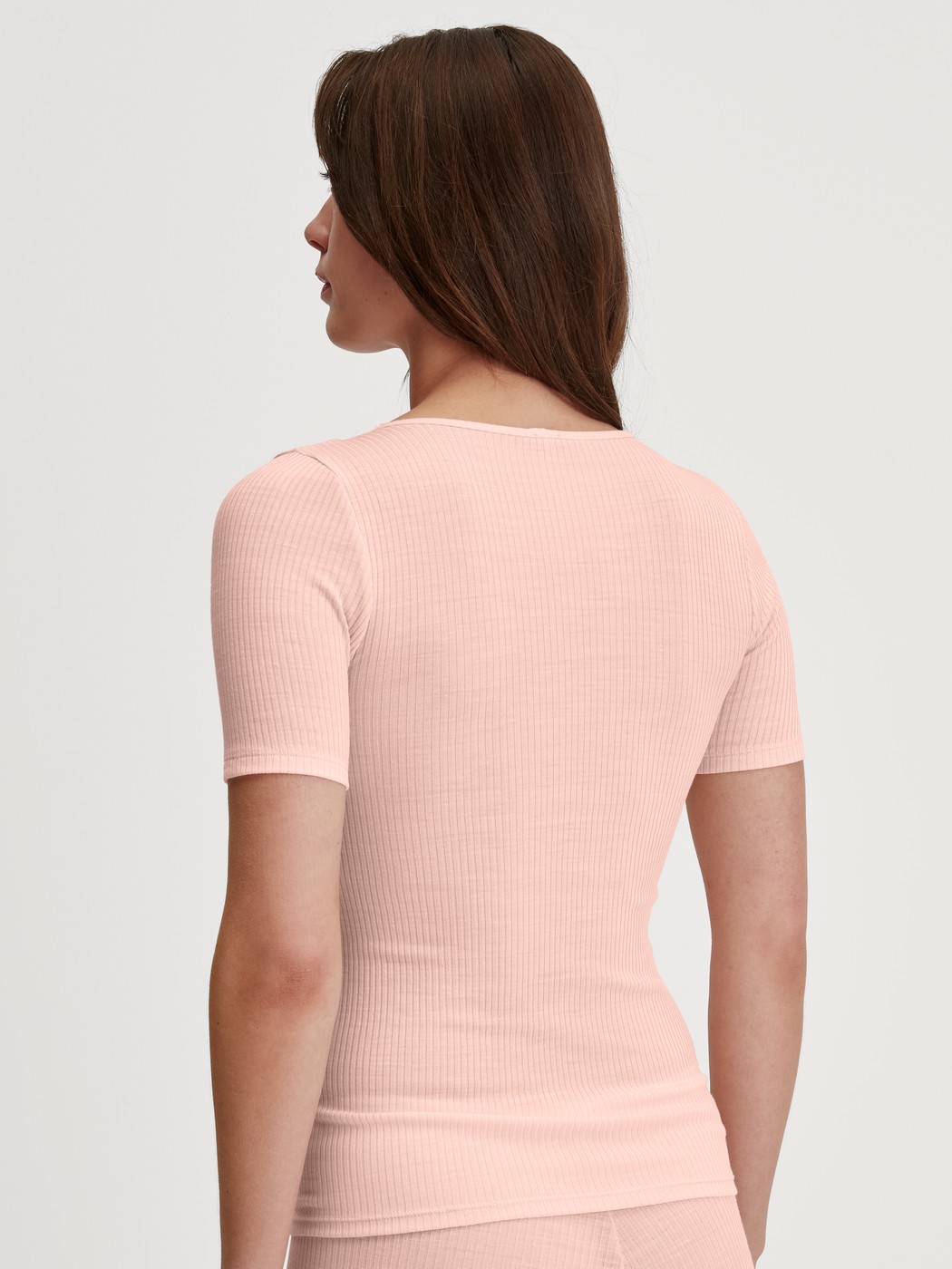 Damen-Model trägt Kurzarm-Shirt aus Wolle-Seide aus Wolle in Rosa, Spitze aus Serie Silky Wool Joy von CALIDA, Rückansicht