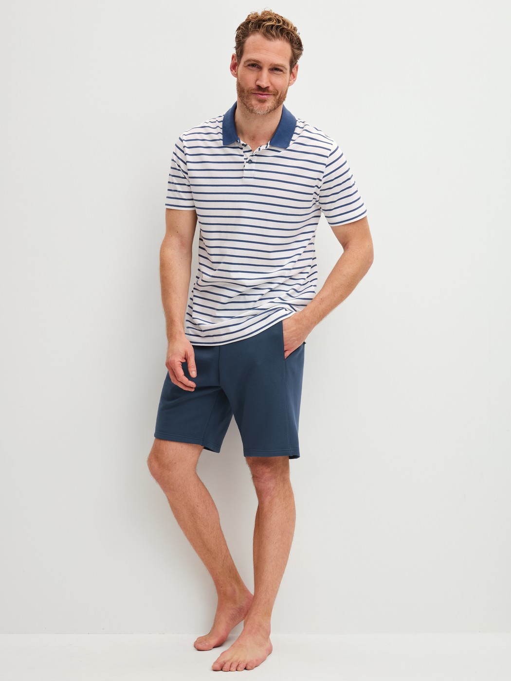 Le mannequin Homme porte le/la polo en 100% coton de couleur Bleu, Rayée, de la série RMX Lounge Journey de CALIDA, Tenue