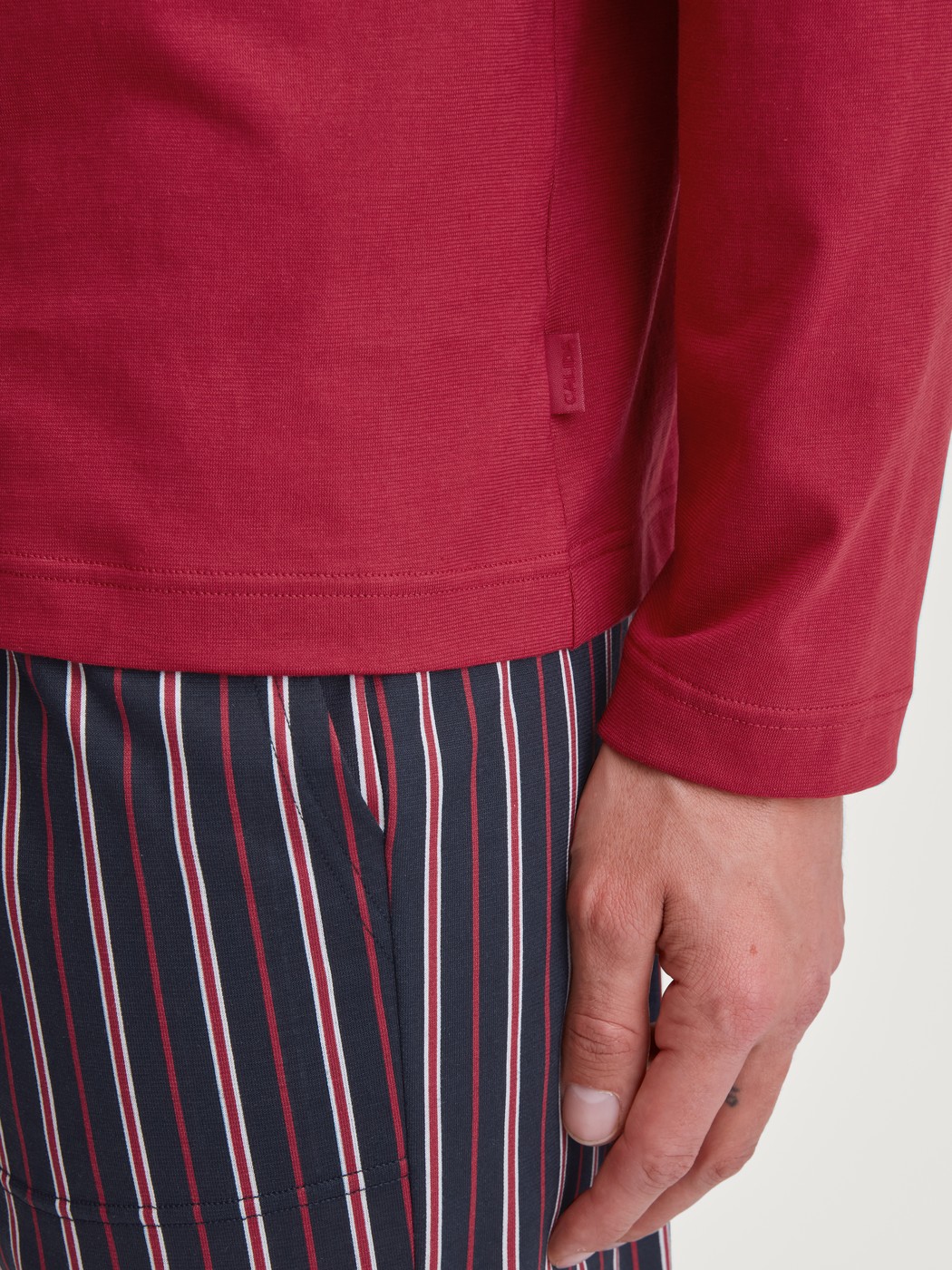 Men model is wearing Shirt long sleeve made of 100% Cotton in Red, Unicoloured from the Remix Basic Sleep series by CALIDA, Detail