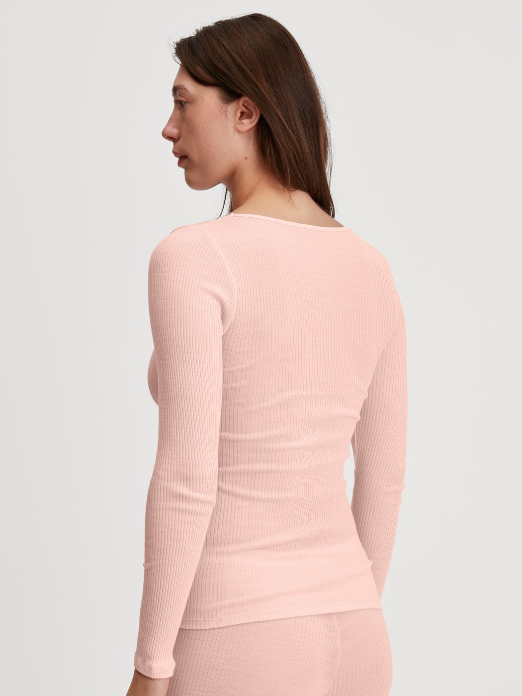 Damen-Model trägt Langarm-Shirt aus Wolle-Seide aus Wolle in Rosa, Spitze aus Serie Silky Wool Joy von CALIDA, Rückansicht