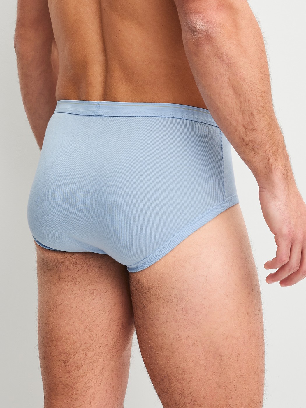 Men model is wearing Classic brief with fly made of 100% Cotton in Blue, Unicoloured from the Twisted Cotton series by CALIDA, Back view