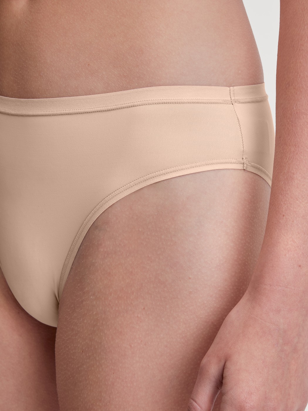 La modella / Il modello Donna indossa Slip in Poliammide di colore Beige, Tinta unita, della serie Sleek Skin di CALIDA, Dettaglio