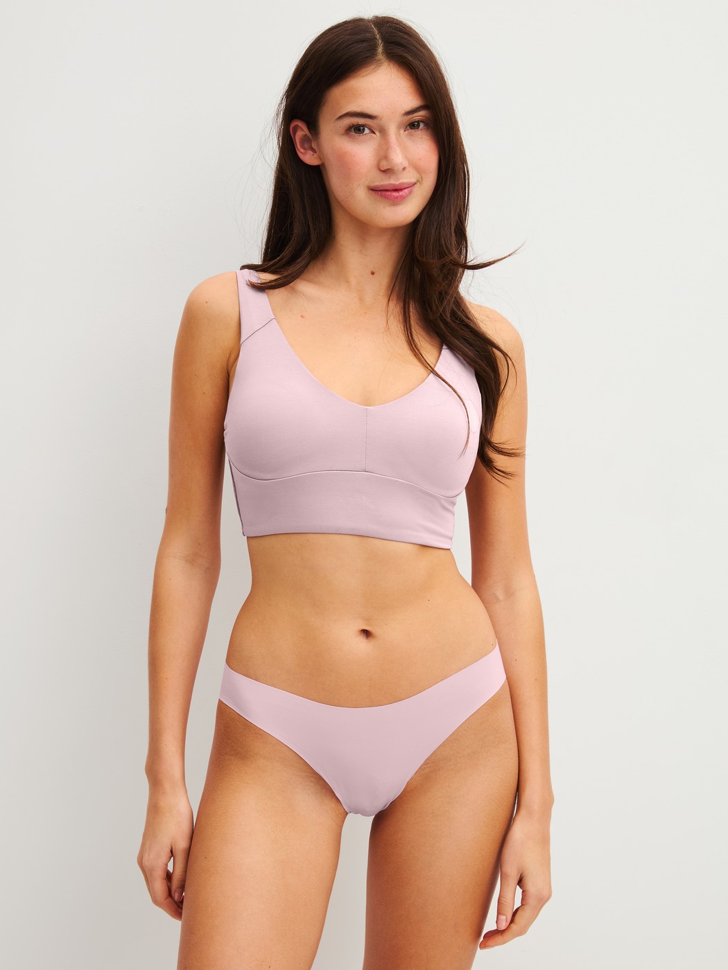 Women model is wearing Seamless Brazilian Brief made of Modal in Purple, Unicoloured from the Natural Skin series by CALIDA, Outfit