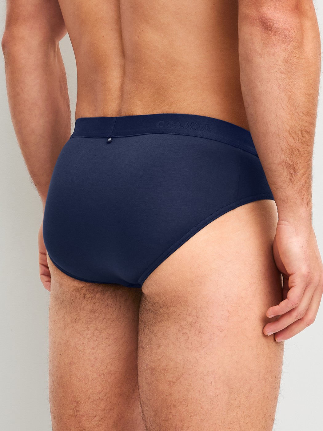 Men model is wearing Brief made of Lyocell in Blue, Unicoloured from the Natural Cooling series by CALIDA, Back view