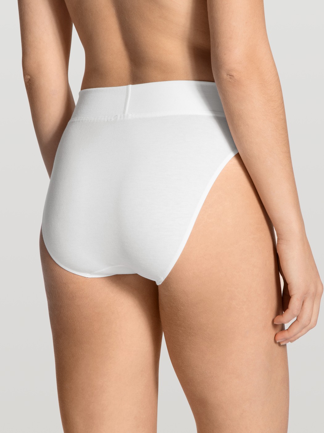 Women model is wearing High Waist Briefs, 2-Pack made of Cotton in Black, Unicoloured from the Elastic Duopack series by CALIDA, Back view
