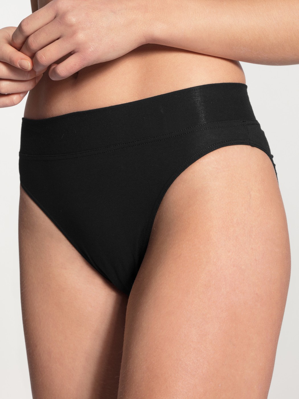 Women model is wearing High Waist Briefs, 2-Pack made of Cotton in Black, Unicoloured from the Elastic Duopack series by CALIDA, Front view