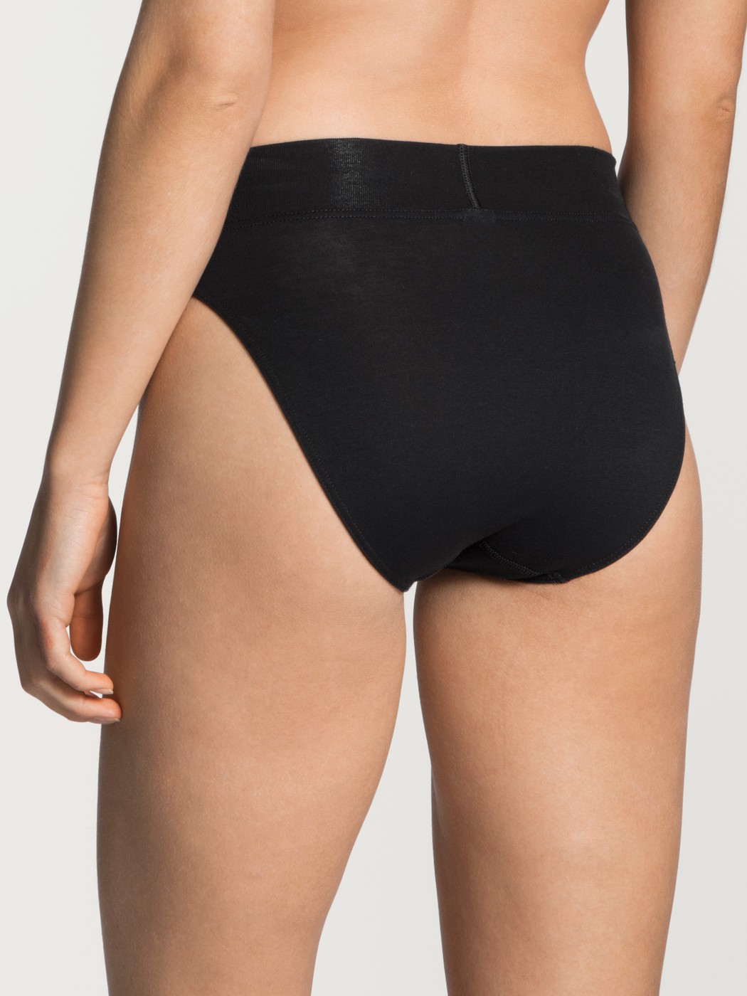Women model is wearing High Waist Briefs, 2-Pack made of Cotton in Black, Unicoloured from the Elastic Duopack series by CALIDA, Back view