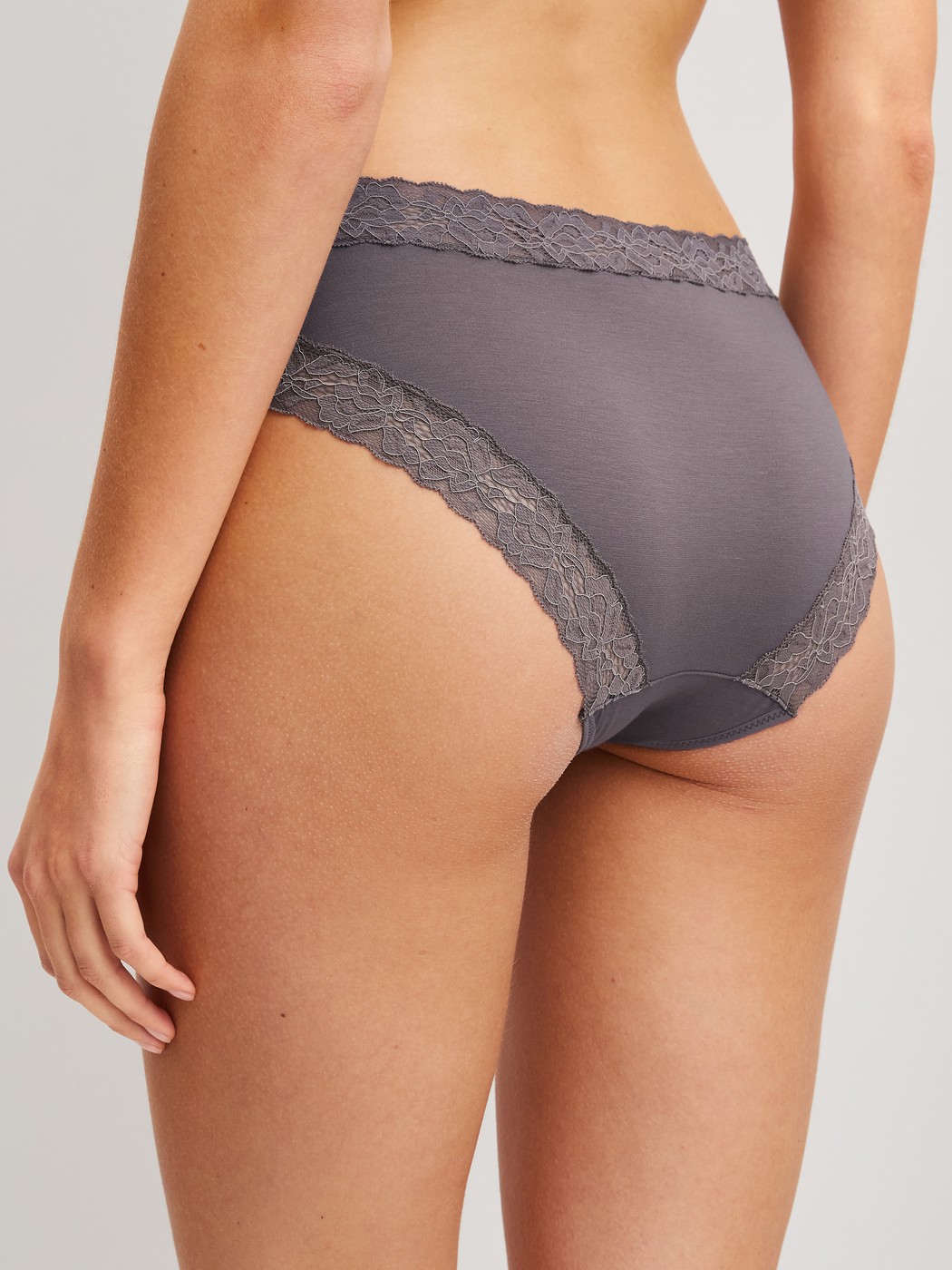Women model is wearing Brief, regular cut made of Cotton in Brown, Lace from the Natural Comfort Lace series by CALIDA, Back view