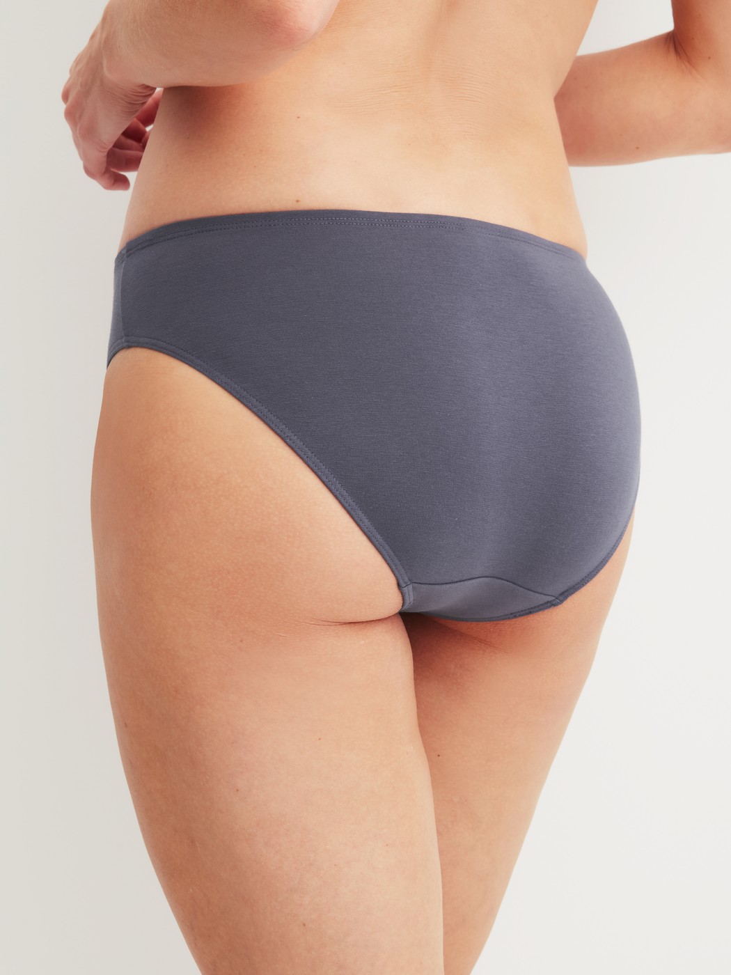 Women model is wearing Brief, regular cut made of Cotton in Grey, Unicoloured from the Essential Cotton series by CALIDA, Back view