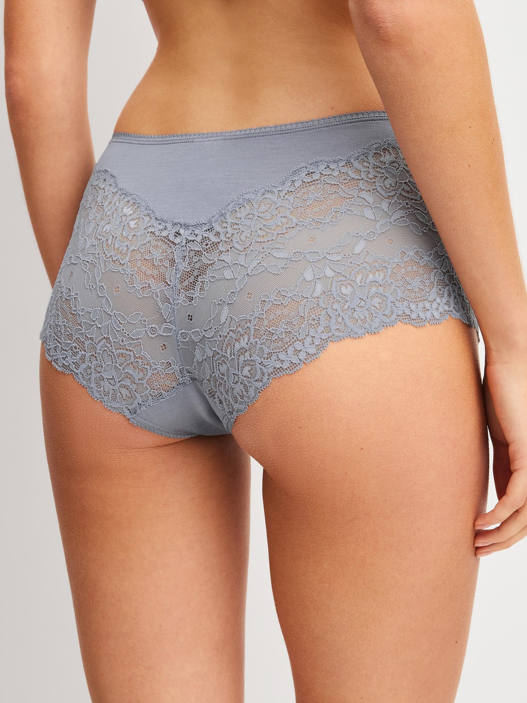 Women model is wearing Shorty regular cut made of Lace in Grey, Lace from the Sensual Secrets series by CALIDA, Back view