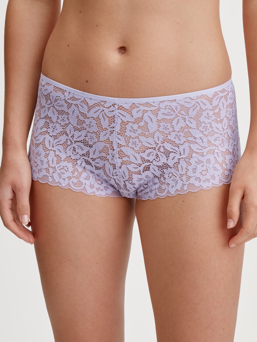 Women model is wearing Shorty regular cut made of Cotton in Purple, Lace from the Natural Comfort Lace series by CALIDA, Front view