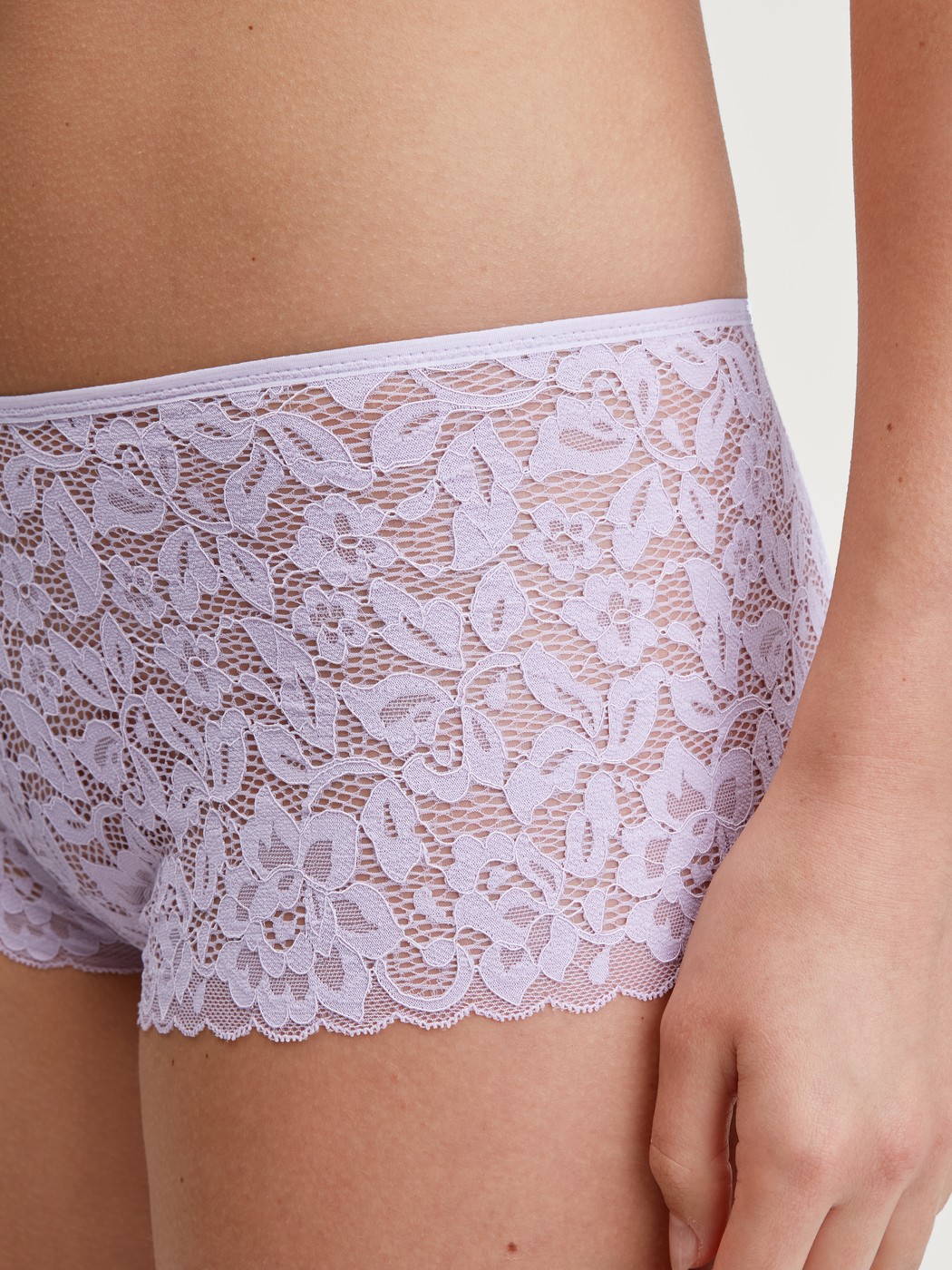 Women model is wearing Shorty regular cut made of Cotton in Purple, Lace from the Natural Comfort Lace series by CALIDA, Detail