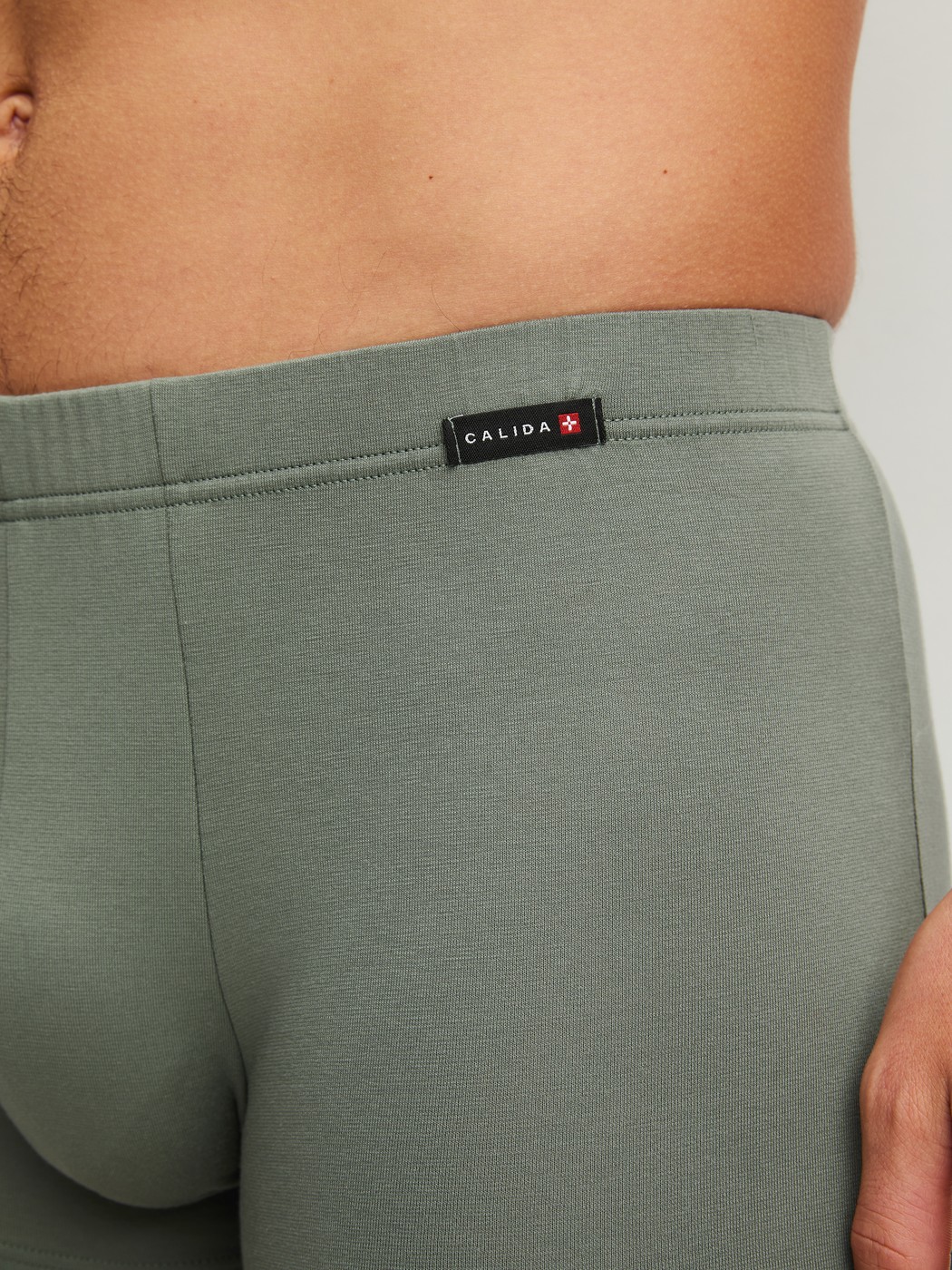 Men model is wearing Boxer brief made of Cotton in Green, Unicoloured from the Evolution series by CALIDA, Detail