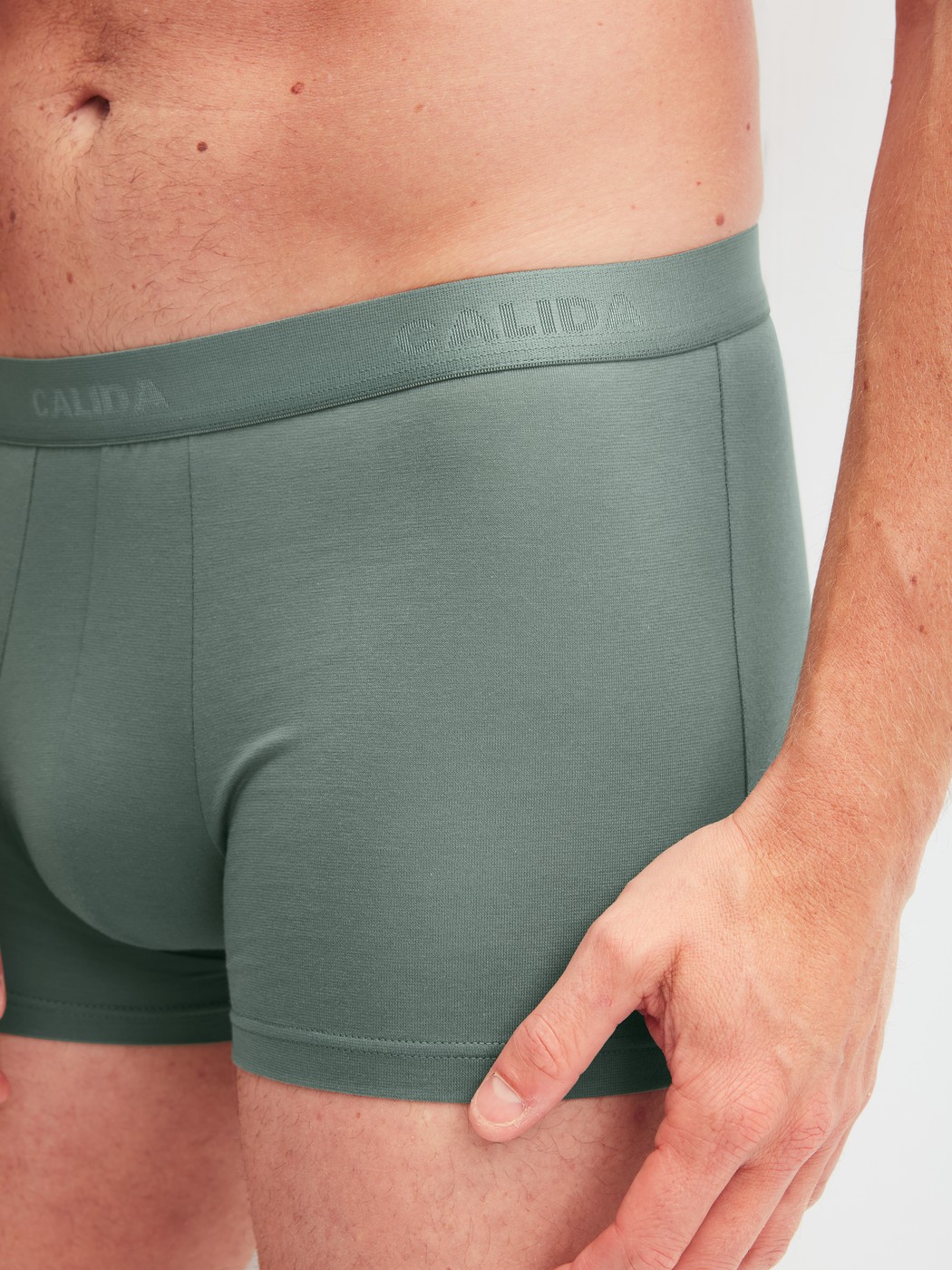 Men model is wearing Boxer brief made of Cotton in Green, Unicoloured from the Evolution series by CALIDA, Front view
