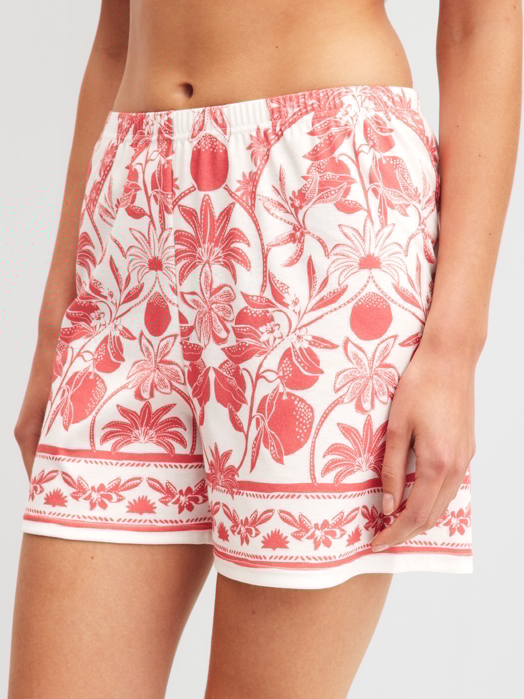 Women model is wearing Pyjama shorts made of 100% Cotton in Orange, Floral from the Favourites Beach series by CALIDA, Front view