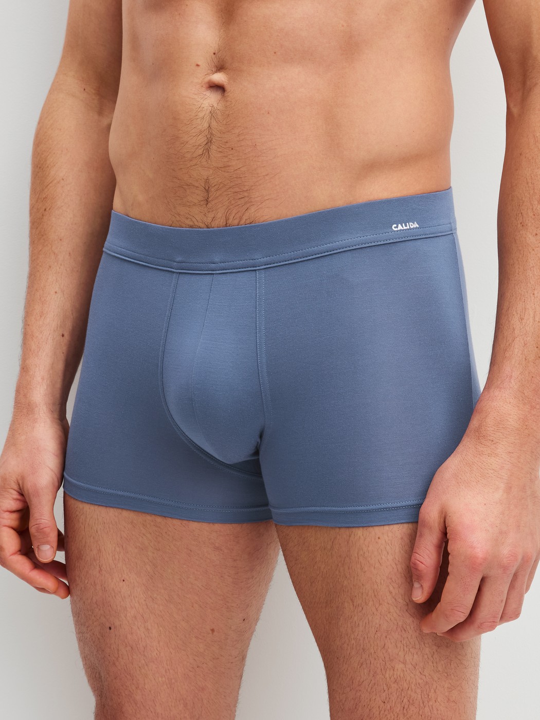 Men model is wearing Boxer brief with Quick Dry Effect made of Modal in Blue, Unicoloured from the Balanced Day series by CALIDA, Front view