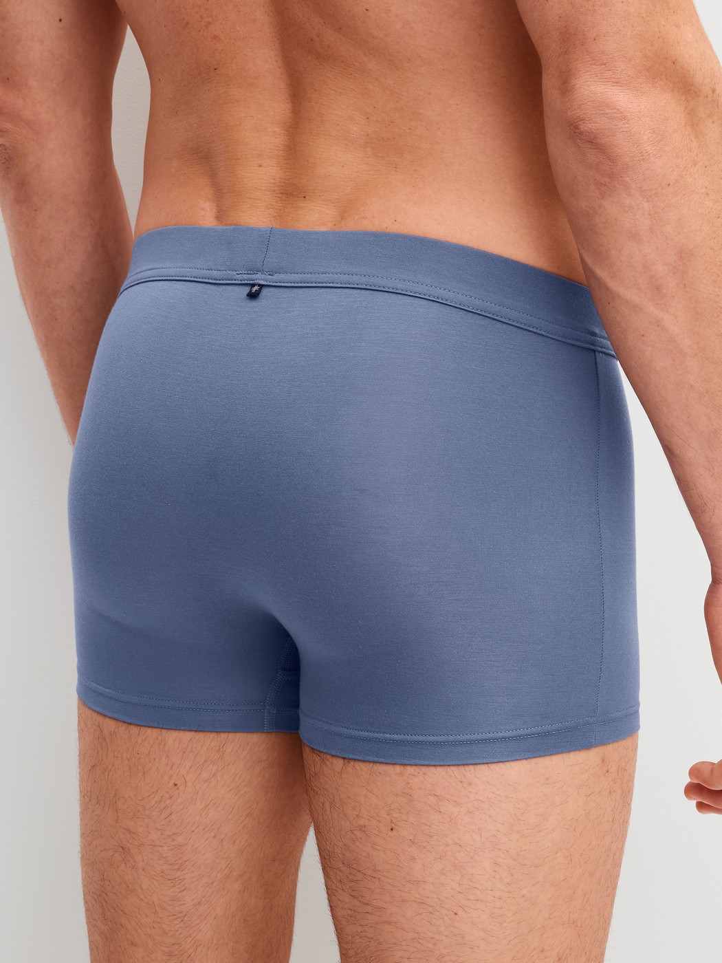 Men model is wearing Boxer brief with Quick Dry Effect made of Modal in Blue, Unicoloured from the Balanced Day series by CALIDA, Back view