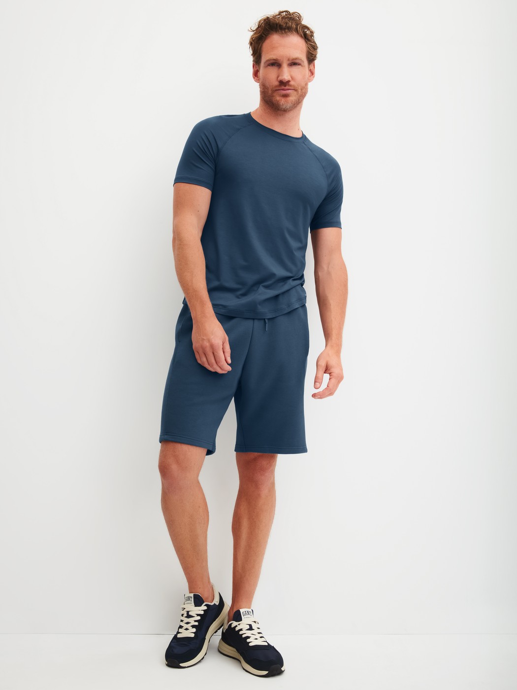 Men model is wearing Bermudas with side pockets made of Cotton in Blue, Unicoloured from the RMX Lounge Journey series by CALIDA, Outfit