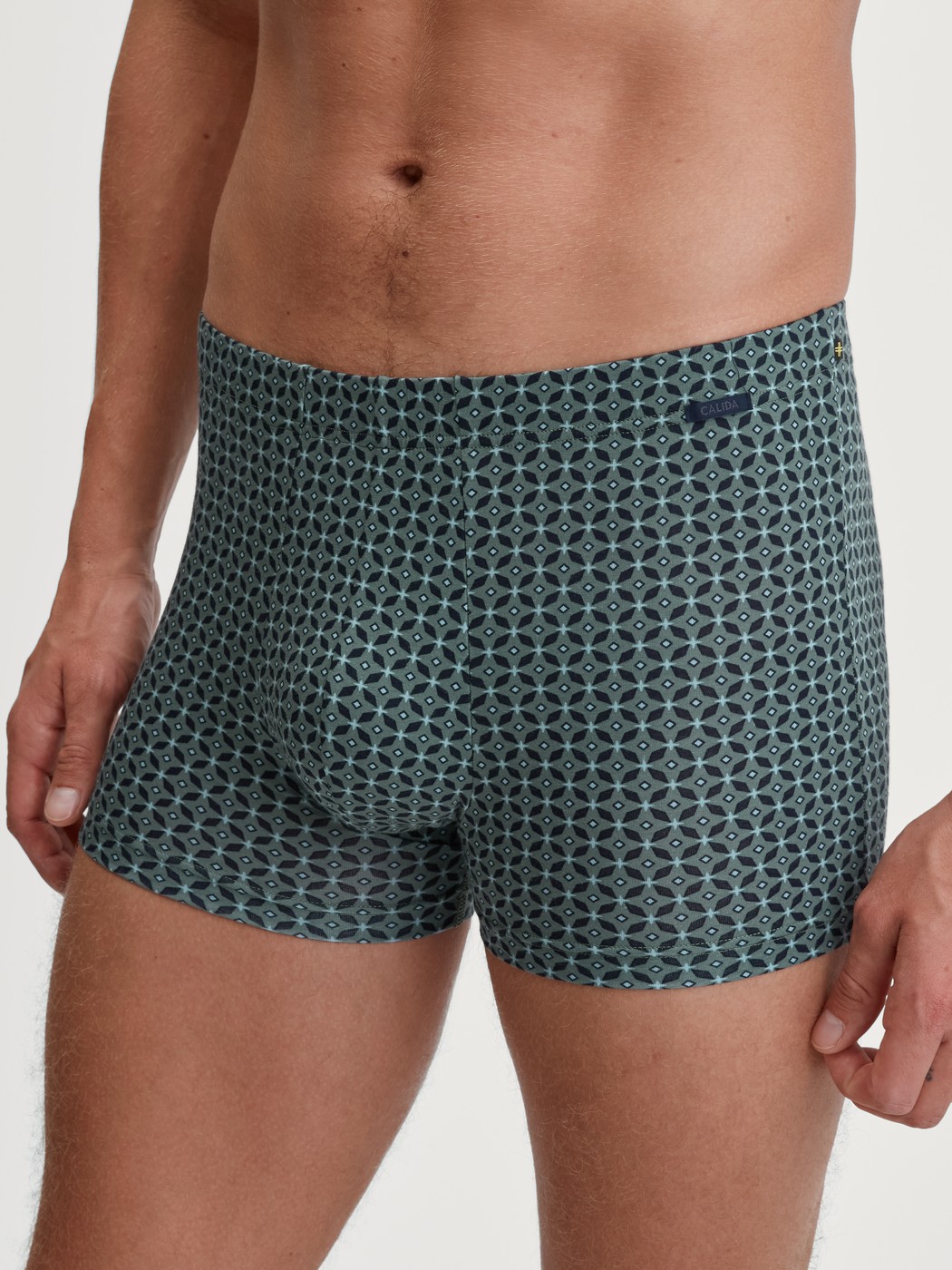 Men model is wearing Boxer brief made of TENCEL™ in Green, Patterned from the Focus Trend series by CALIDA, Front view