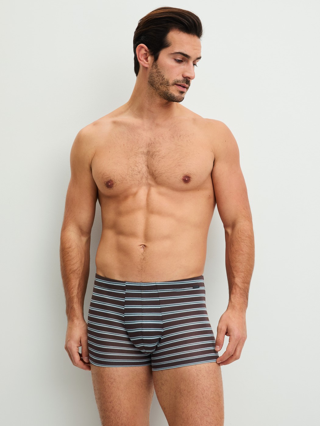 Men model is wearing Boxer brief made of Lyocell in Brown, Striped from the Focus Trend series by CALIDA, Outfit