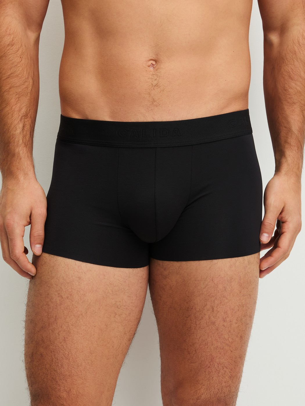 Men model is wearing Boxer brief with elastic waistband made of Modal in Black, Unicoloured from the Clean Line series by CALIDA, Front view