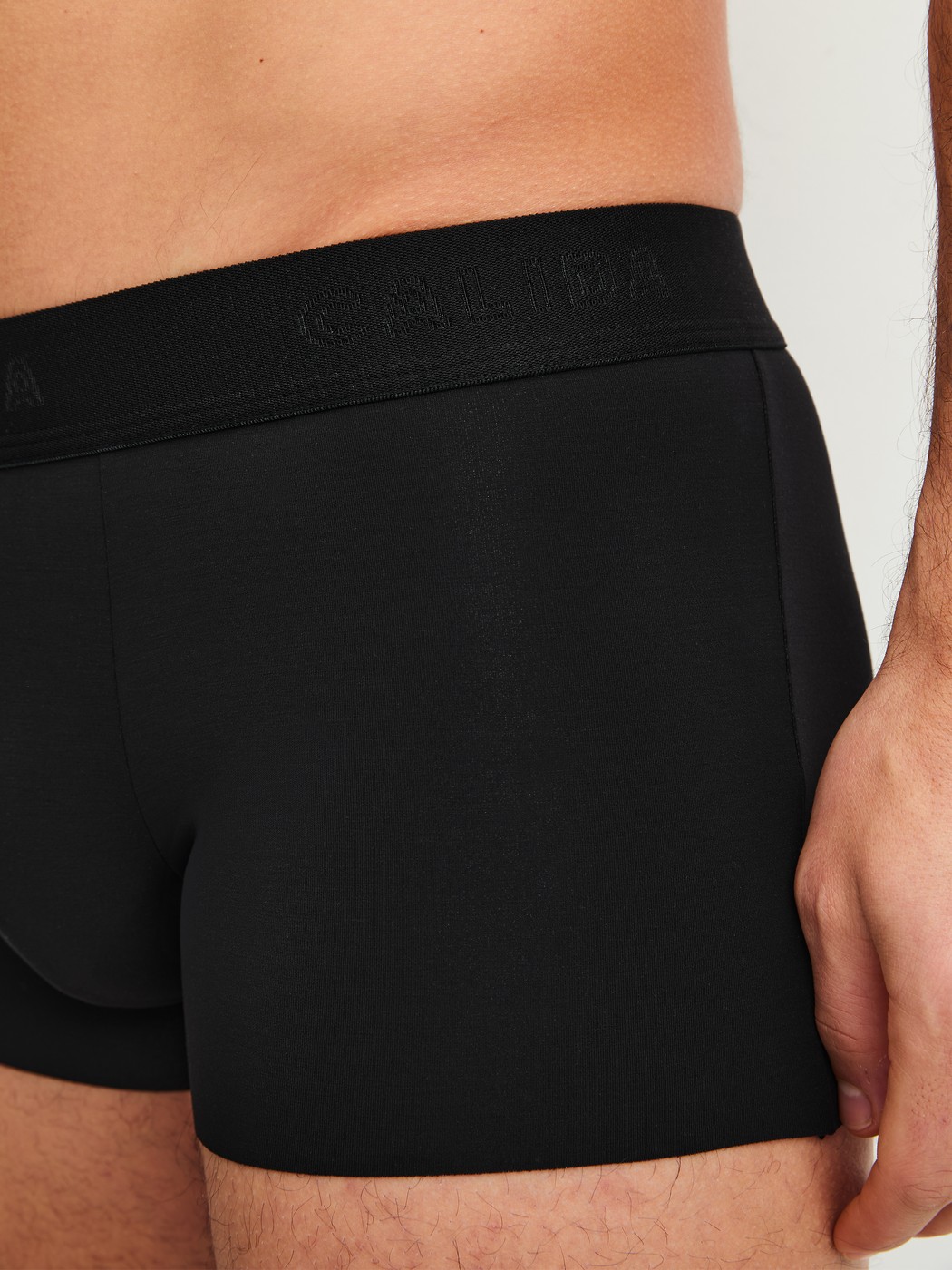 Men model is wearing Boxer brief with elastic waistband made of Modal in Black, Unicoloured from the Clean Line series by CALIDA, Detail