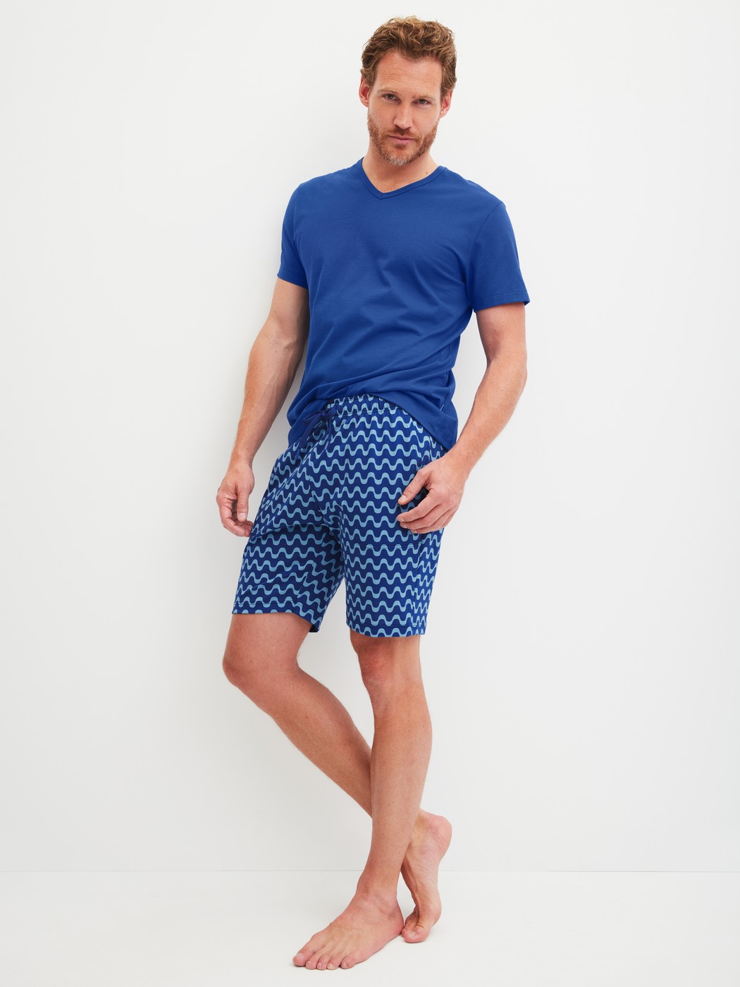 Herren-Model trägt Bermudas aus 100% Baumwolle in Blau, Gemustert aus Serie RMX Sleep Time off von CALIDA, Outfit