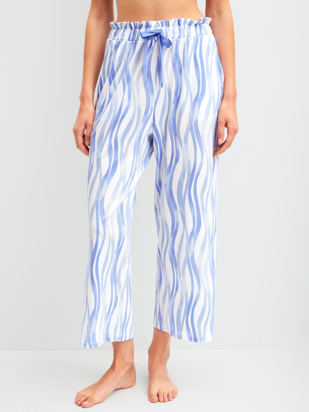 Women model is wearing 7/8 pyjama trousers made of Cotton in Blue, Patterned from the Favourites Ocean series by CALIDA, Front view