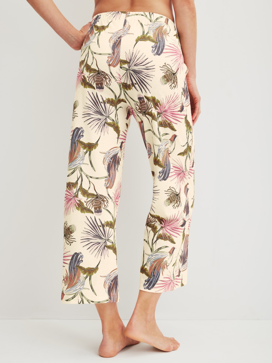 Women model is wearing 7/8 pyjama trousers made of 100% Cotton in Beige, Floral from the Favourites Arts series by CALIDA, Back view