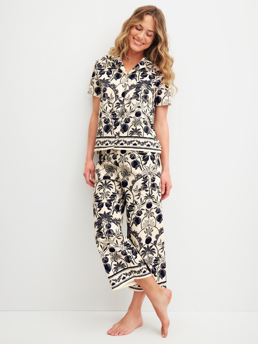 Women model is wearing 7/8 pyjama trousers made of 100% Cotton in Beige, Floral from the Favourites Layering series by CALIDA, Outfit