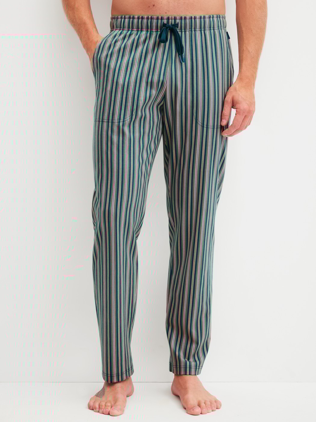 Men model is wearing Pyjama Bottoms with Side Pockets made of 100% Cotton in Green, Striped from the RMX Sleep Leisure series by CALIDA, Front view