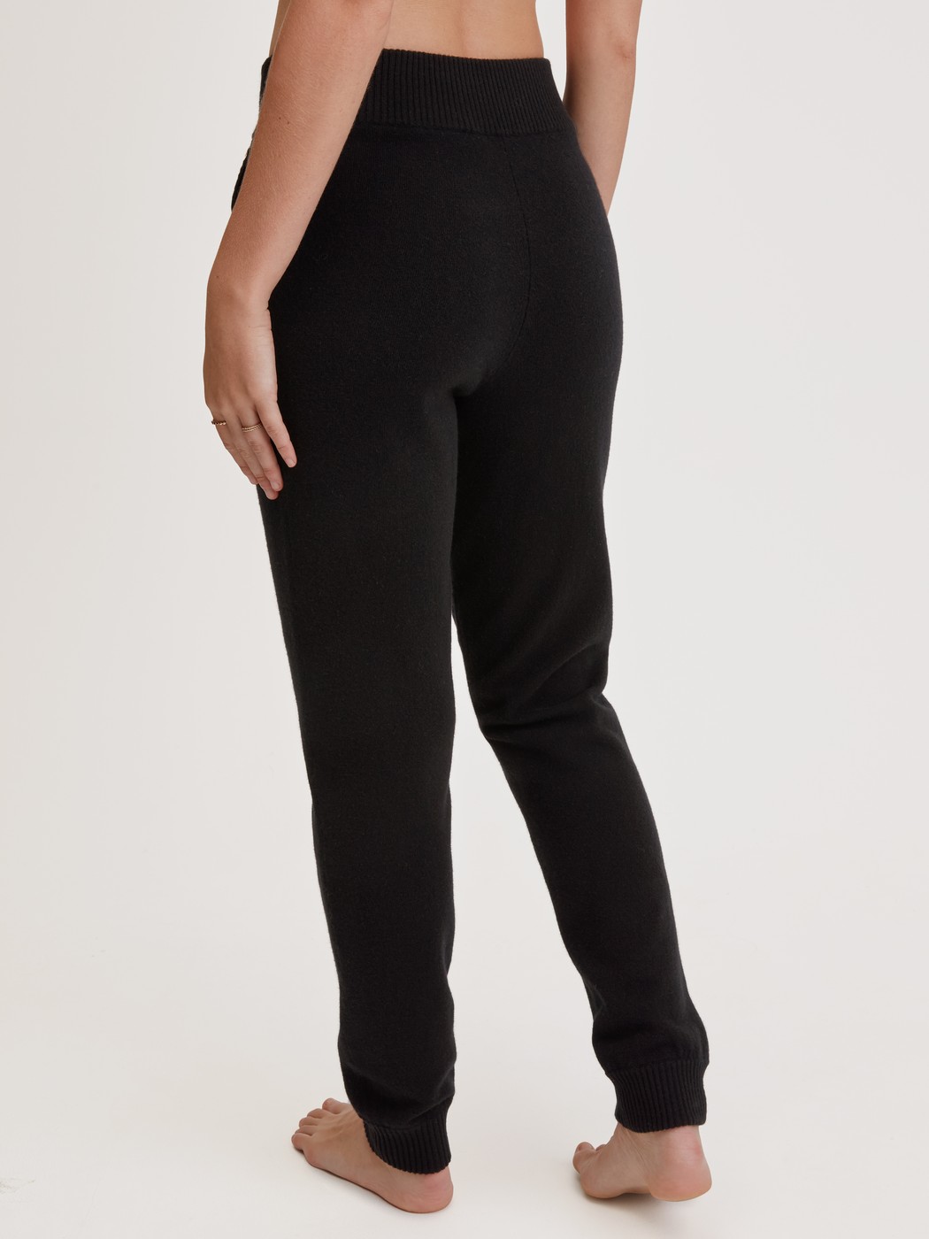 Women model is wearing Merino wool knitted trousers made of Wool in Black, Unicoloured from the The Cosy Collection series by CALIDA, Back view