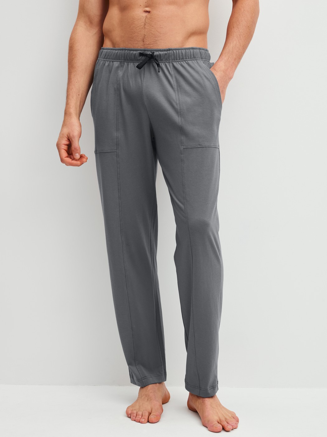 Men model is wearing Pyjama Bottoms with Side Pockets made of 100% Cotton in Grey, Unicoloured from the RMX Sleep Leisure series by CALIDA, Front view