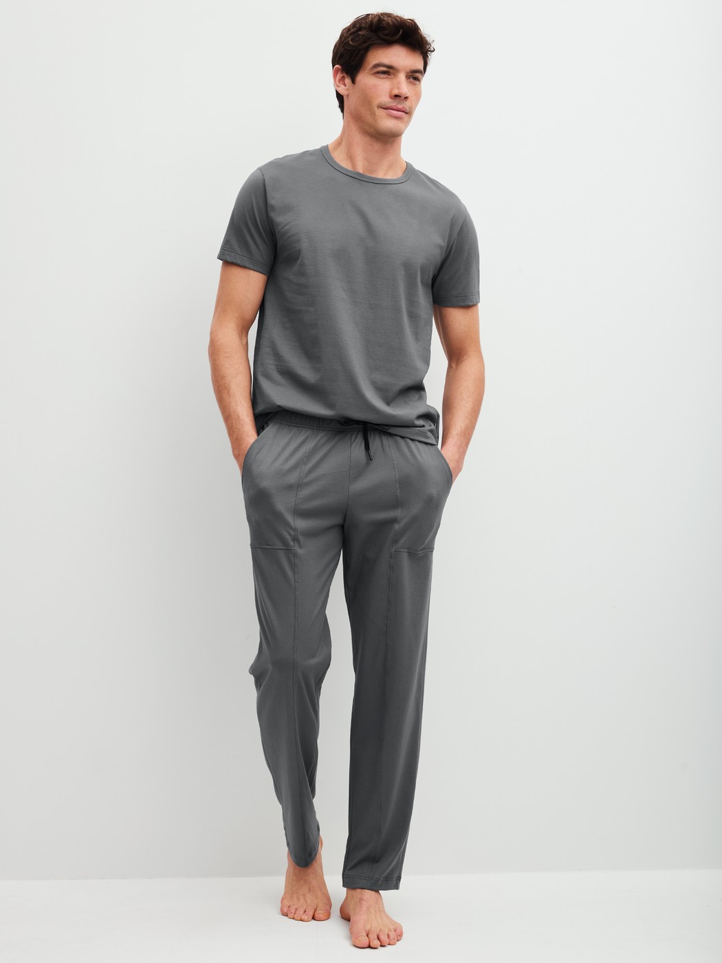 Men model is wearing Pyjama Bottoms with Side Pockets made of 100% Cotton in Grey, Unicoloured from the RMX Sleep Leisure series by CALIDA, Outfit