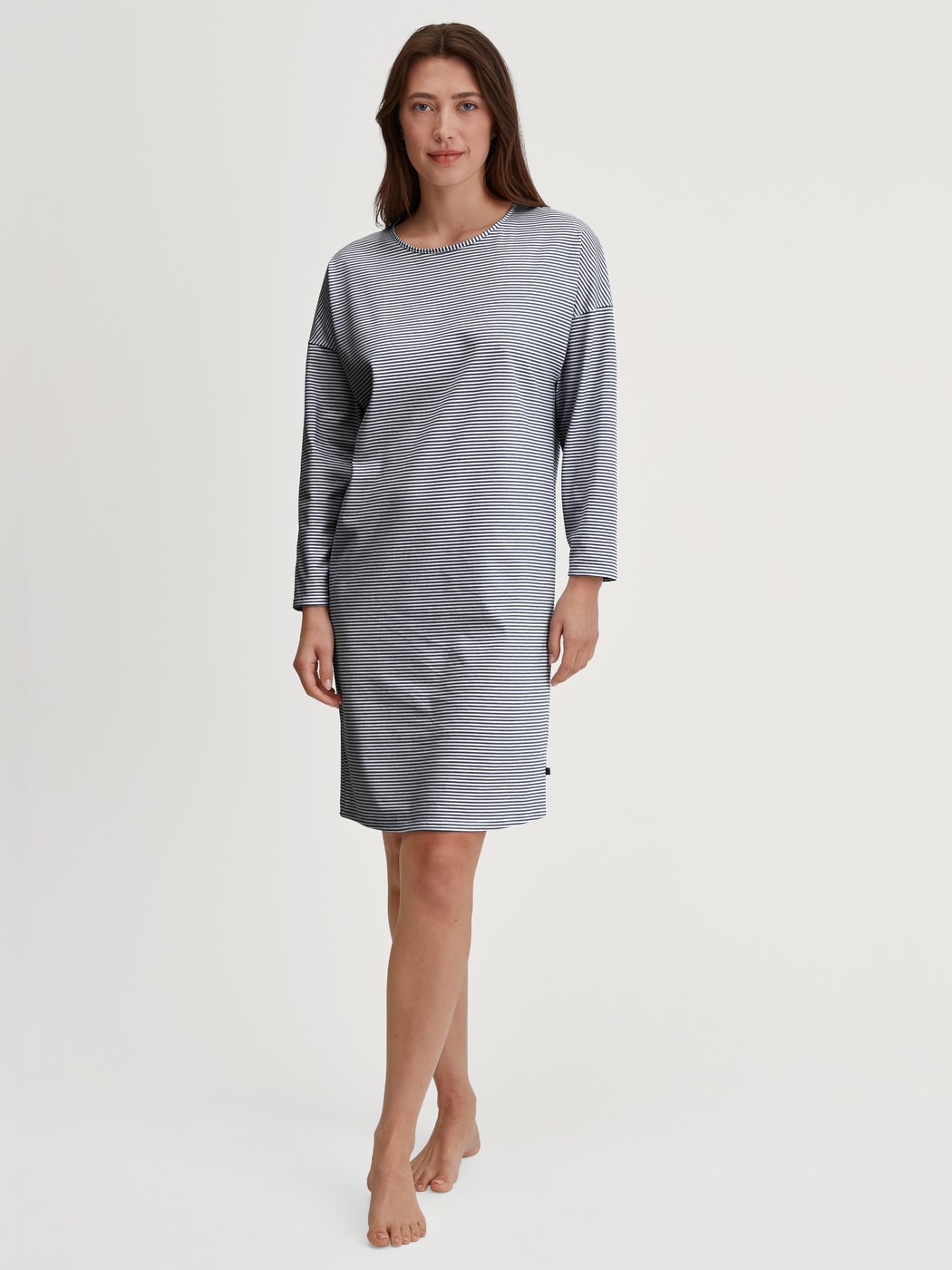Women model is wearing Long Sleeve Nightdress –100 cm Length made of 100% Cotton in Blue, Patterned from the Cotton Special series by CALIDA, Front view