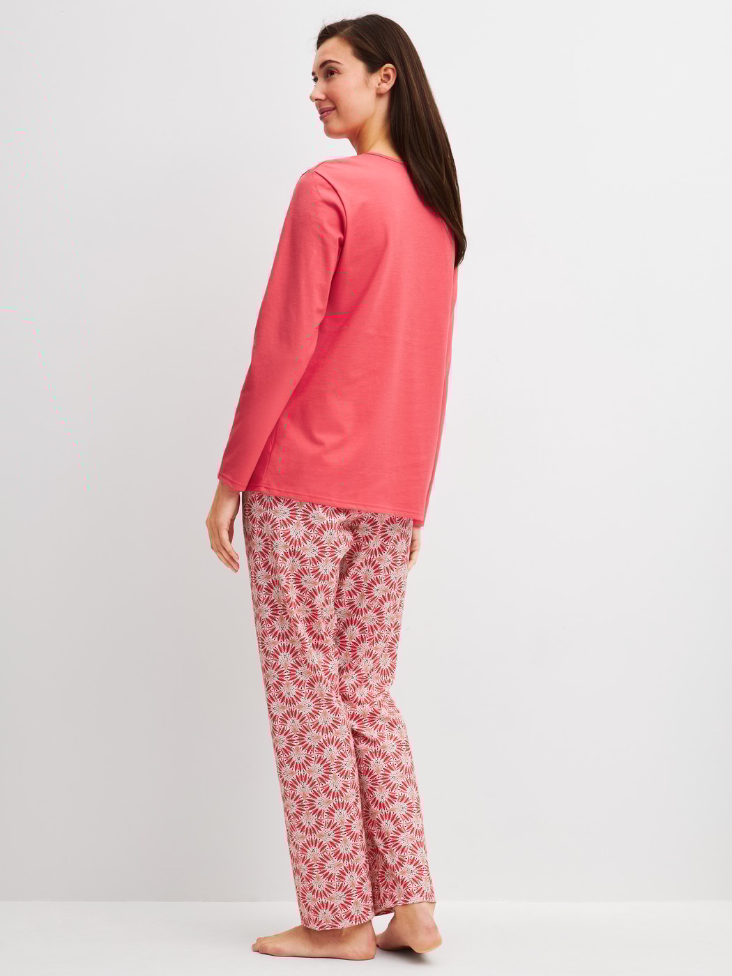 Women model is wearing Pyjamas, long made of 100% Cotton in Red, Patterned from the Cotton Special series by CALIDA, Back view