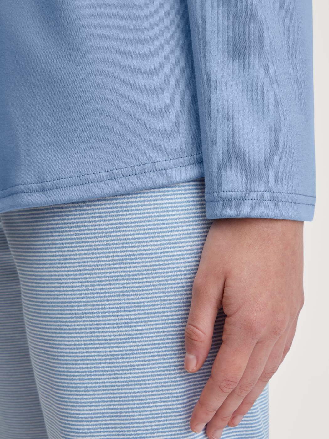 Women model is wearing Pyjamas, long made of 100% Cotton in Blue, Striped from the Midnight Stripes series by CALIDA, Detail