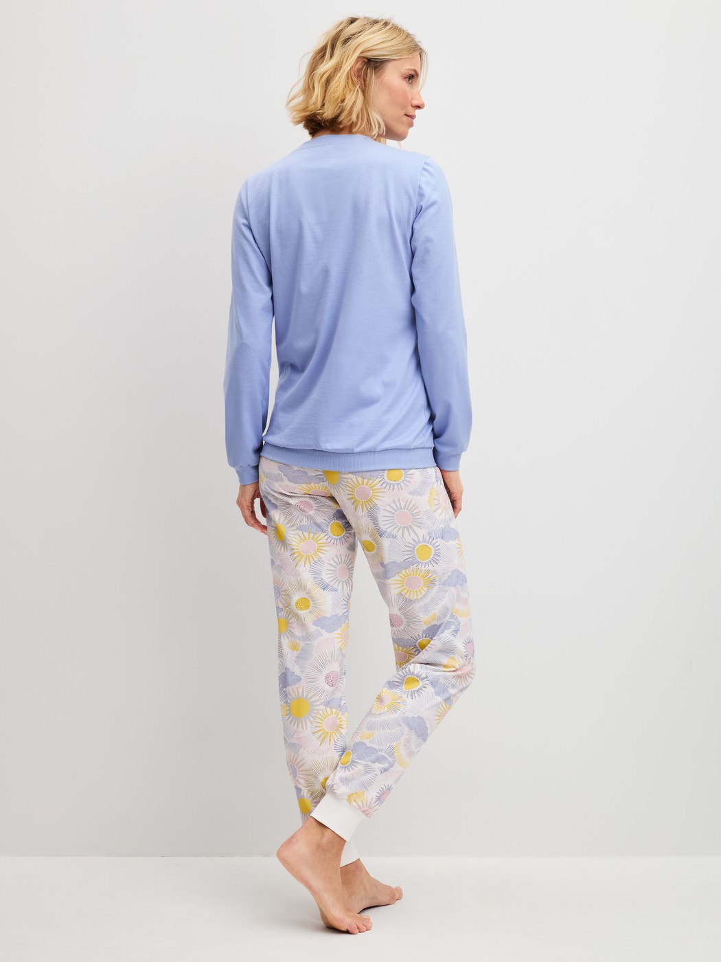 Women model is wearing Pyjama with cuff made of 100% Cotton in Blue, Patterned from the EDITION 85 series by CALIDA, Back view