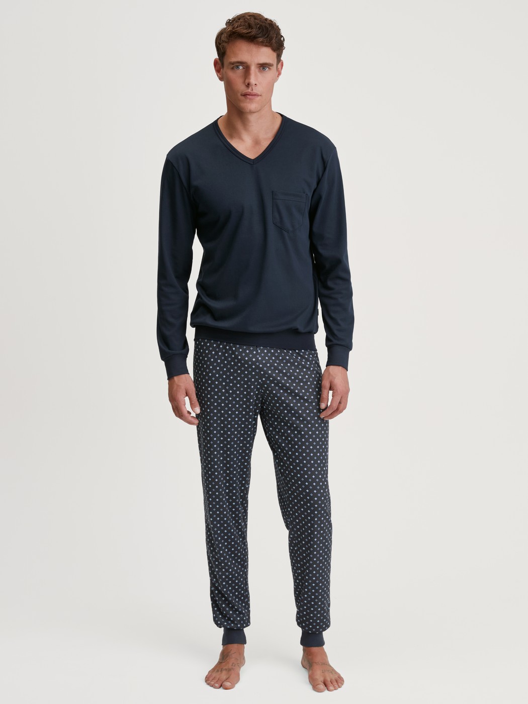 Men model is wearing Pyjama with cuff made of 100% Cotton in Blue, Patterned from the Relax Streamline series by CALIDA, Front view