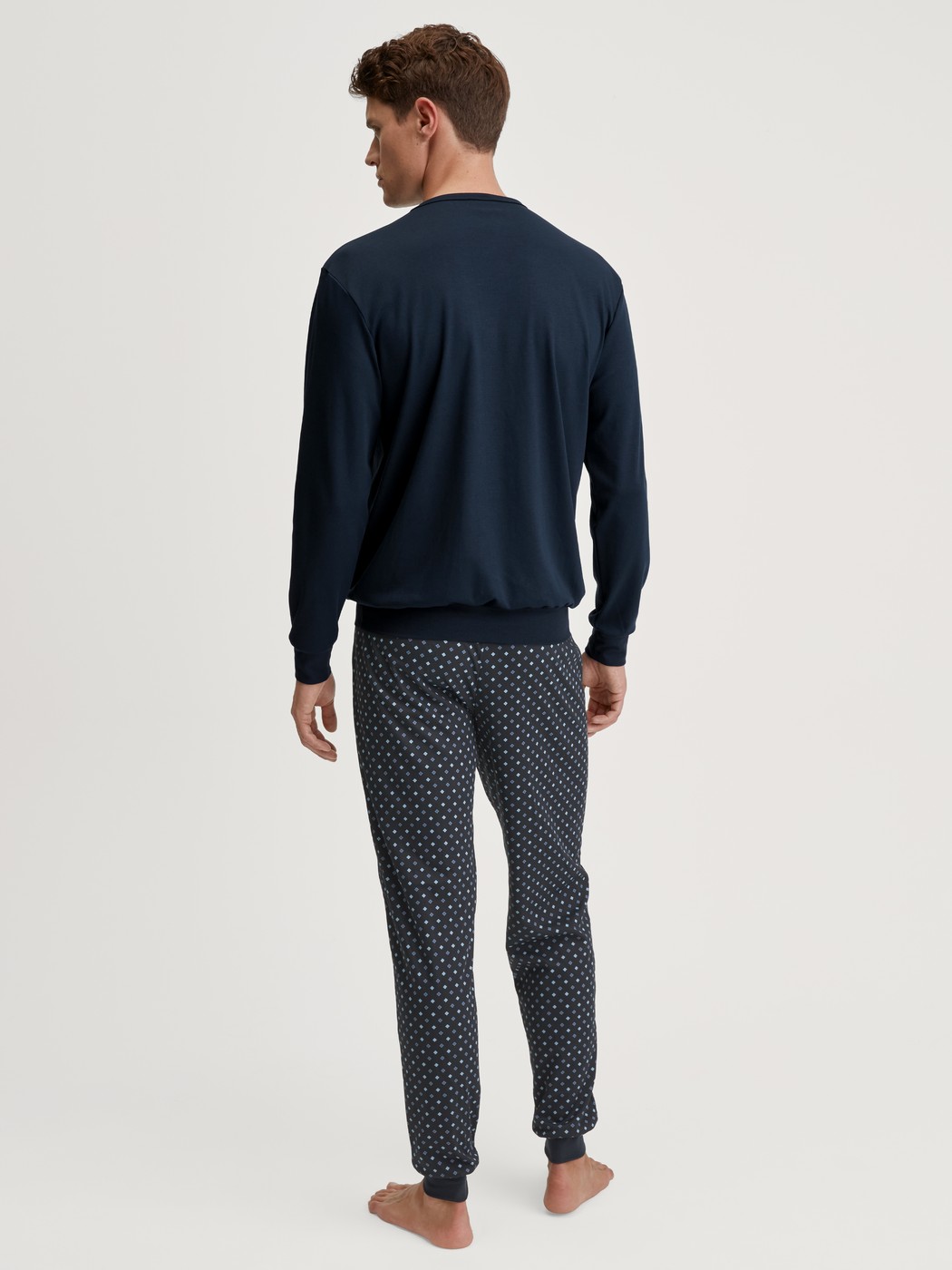 Men model is wearing Pyjama with cuff made of 100% Cotton in Blue, Patterned from the Relax Streamline series by CALIDA, Back view